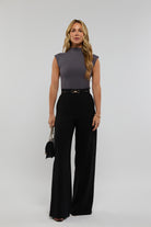 Chic grey bodysuit styled with high-waisted trousers – a versatile, timeless staple for effortless elegance. Ashly Rae